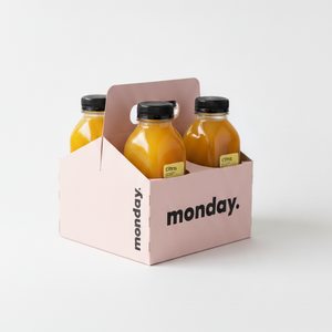 Citrus cold-pressed juice bottles in a pink carrier, designed for refreshing immune-boosting drinks.