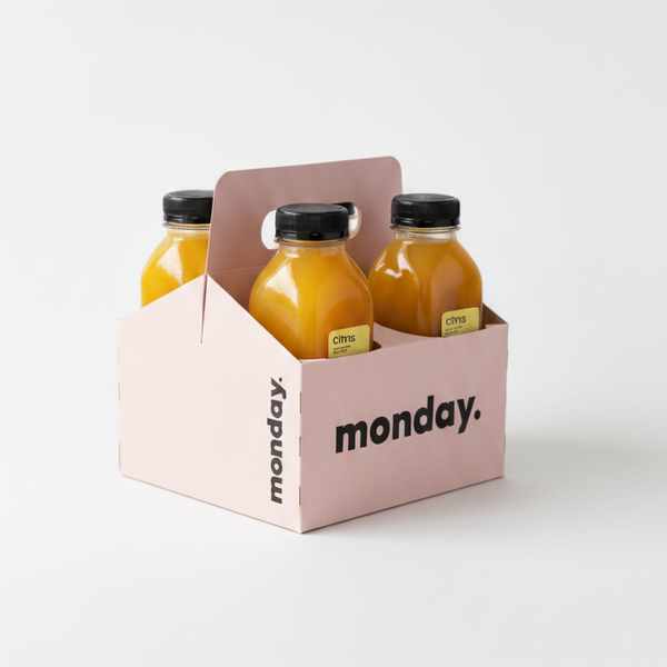 Citrus cold-pressed juice bottles in a pink carrier, designed for refreshing immune-boosting drinks.