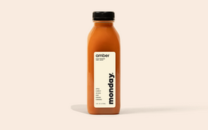 Amber Cold-Pressed Juice bottle featuring apple, carrot, lime, ginger, and turmeric for a healthy glow.
