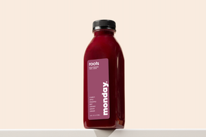 Roots Cold-pressed Juice bottle featuring carrot, apple, pineapple, ginger, and lemon.